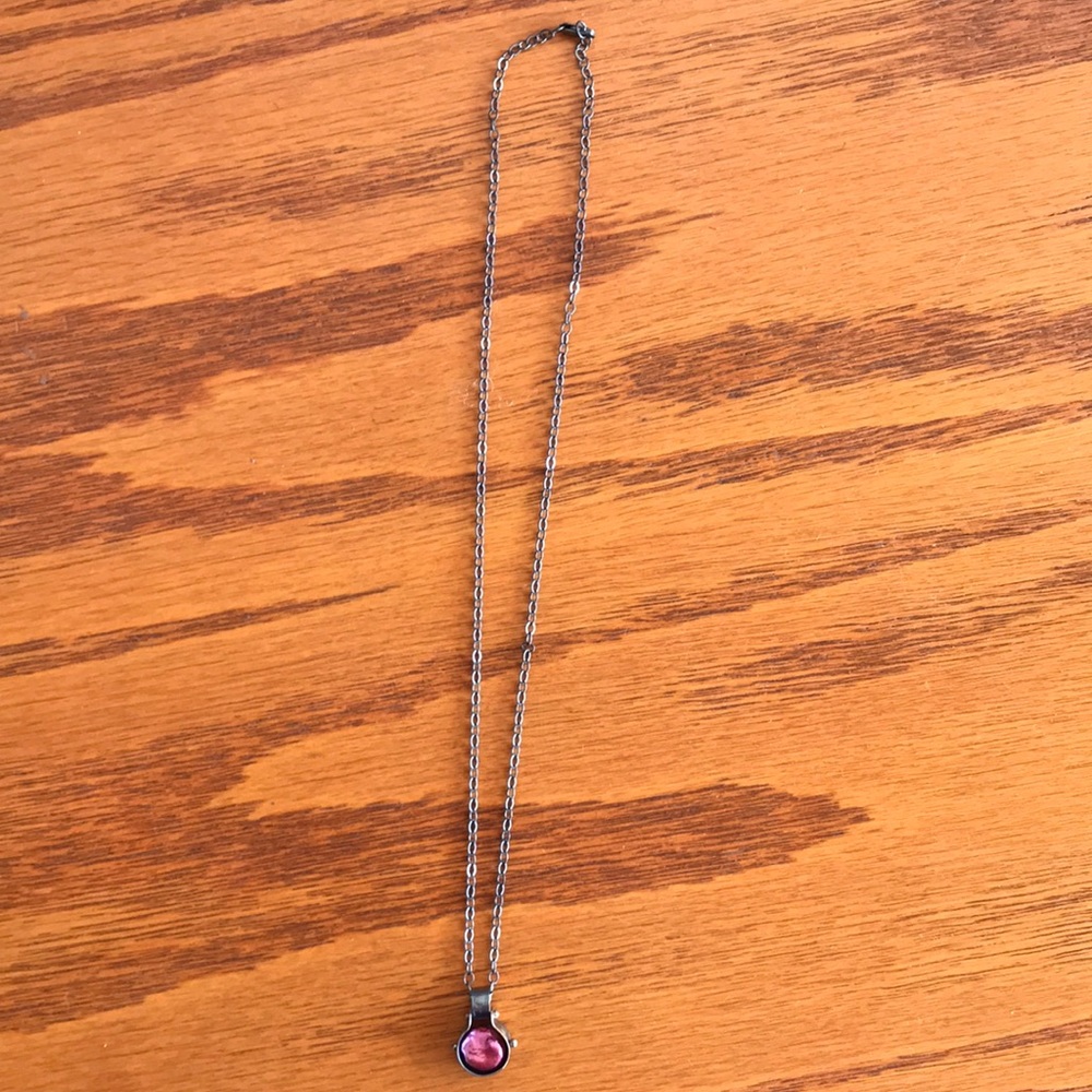 Dark metallic necklace with purple gem pendant
